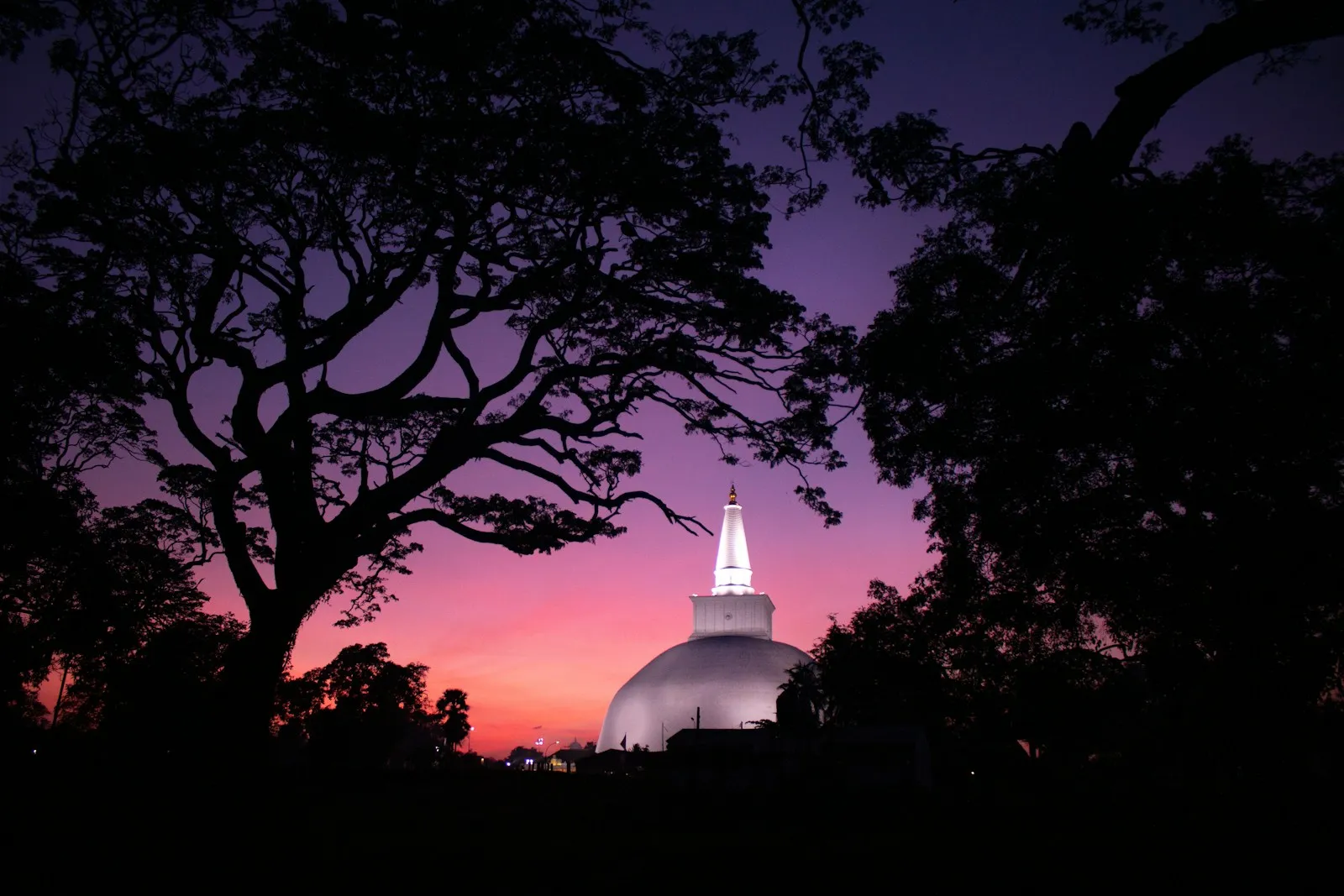 Photo by Chathura Anuradha Subasinghe a white building with a dome and trees in the foreground
