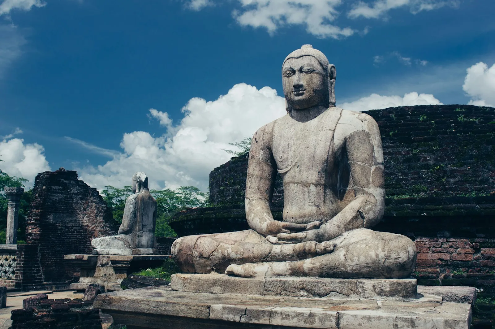 Photo by Vlada a statue of a person sitting in a meditation position