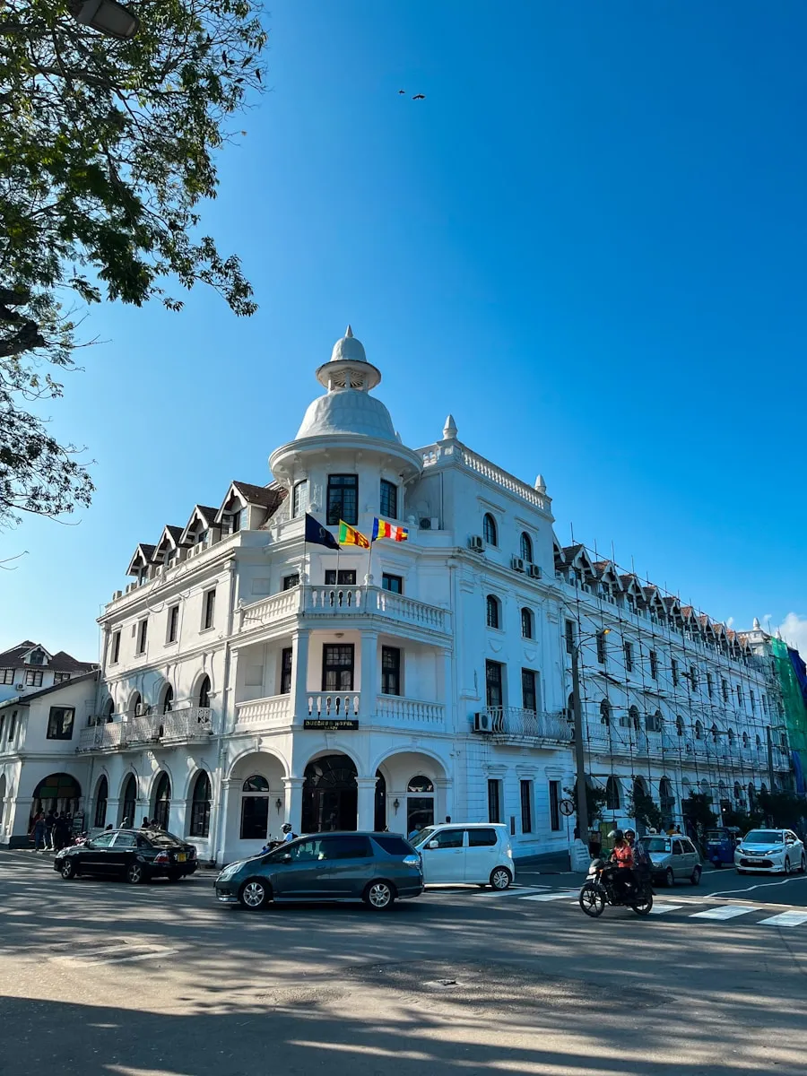 Photo by Akhila Kanampella a large white building sitting on the side of a road
